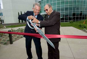 Rich DeVos and Jay Van Andel cut a red ribbon at the opening of Amway’s Nutrilite Center for Optimal Health in Buena Park, California.