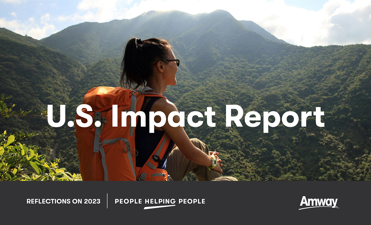 Amway US Impact report cover of woman with a hiking backpack sitting on a mountain looking out over a vista