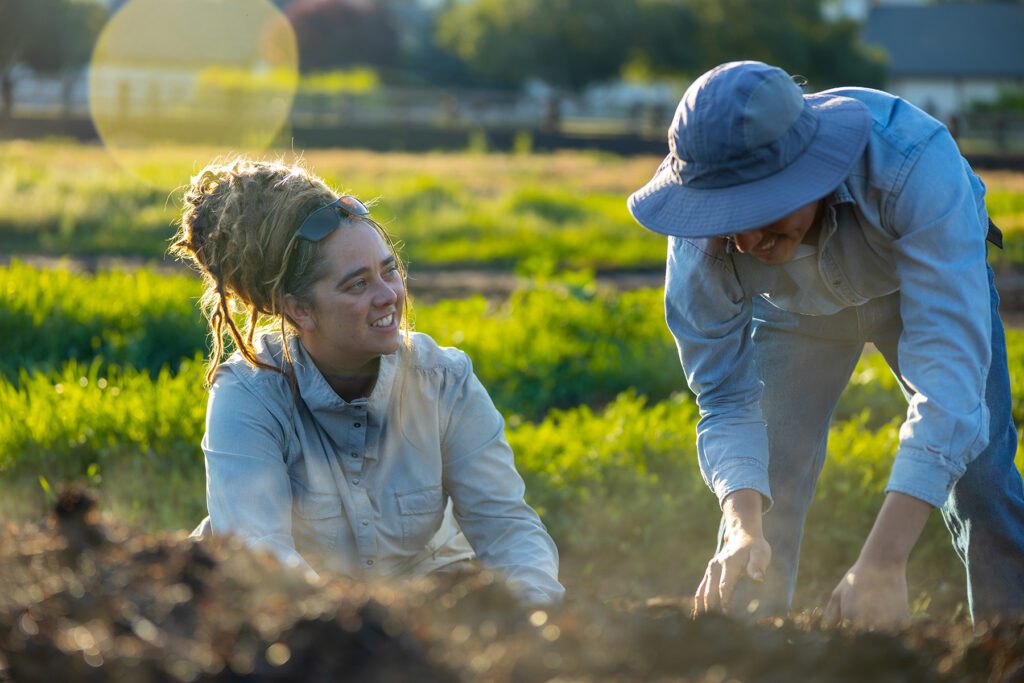 Danielle Kruse, Farm Manager, sits next to a farm worker at Trout Lake farms in Washington state.